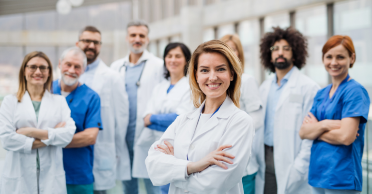 Image of a group of doctors facing the camera, signifying unity and professionalism. Caption: 'Recognizing the Power of Locum Tenens Staffing Agencies in Healthcare'
