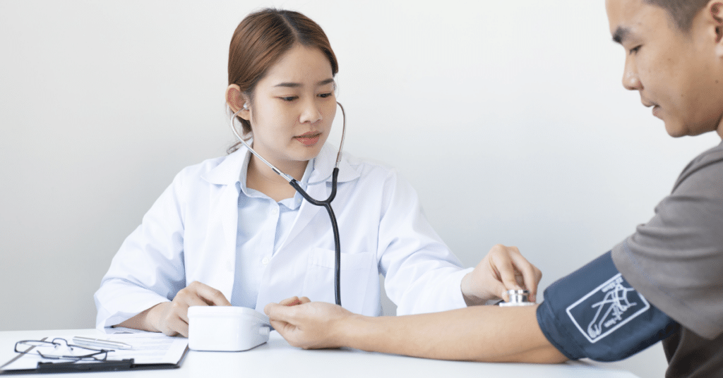 Locum Physician Assistant measuring patient's blood pressure in a hospital setting with stethoscope. Overview of Locum PA roles and responsibilities.