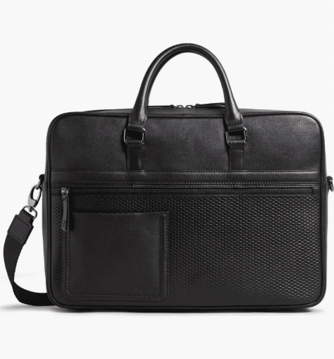 Ted Baker London Canvess Textured Leather Briefcase: A stylish and sophisticated briefcase featuring a finely textured leather exterior. The design showcases the signature Ted Baker elegance, with sleek lines and a polished finish. The briefcase includes a sturdy handle and a shoulder strap, providing versatility in carrying options. The interior is well-organized with multiple compartments, ideal for storing documents, gadgets, and personal items securely.
